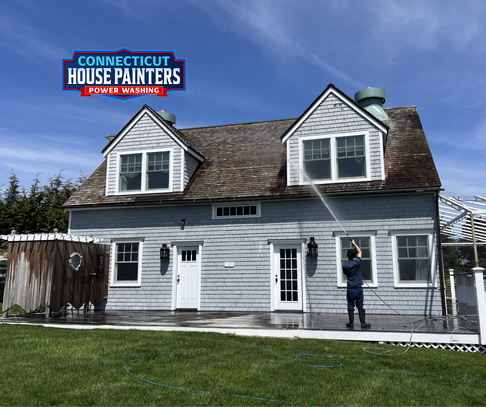 Technician power washing a Connecticut boathouse